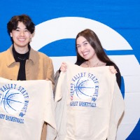 Boy and girl with sweatshirts in hand